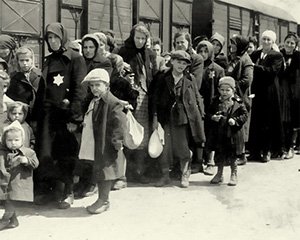 Jewish families from Hungary disembark from the railway cattle cars that had transported them across Europe to an almost certain death at the Auschwitz-Birkenau death camp in Poland during World War Two.