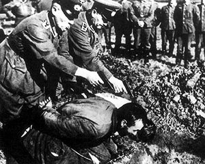 Nazi SS Einsatzgruppen executioners murdering two Jewish men in cold blood at a mass execution of innocent Jewish people in Ukraine, 1942.